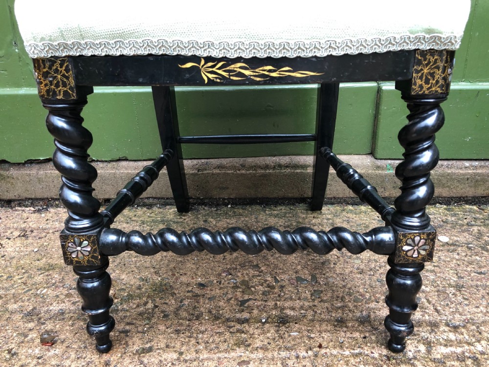 A pair of black lacquered Victorian bedroom chairs featuring oval back panels painted with floral motifs, mother-of-pearl inlay, barley twist legs, and light green upholstered seats. View XII