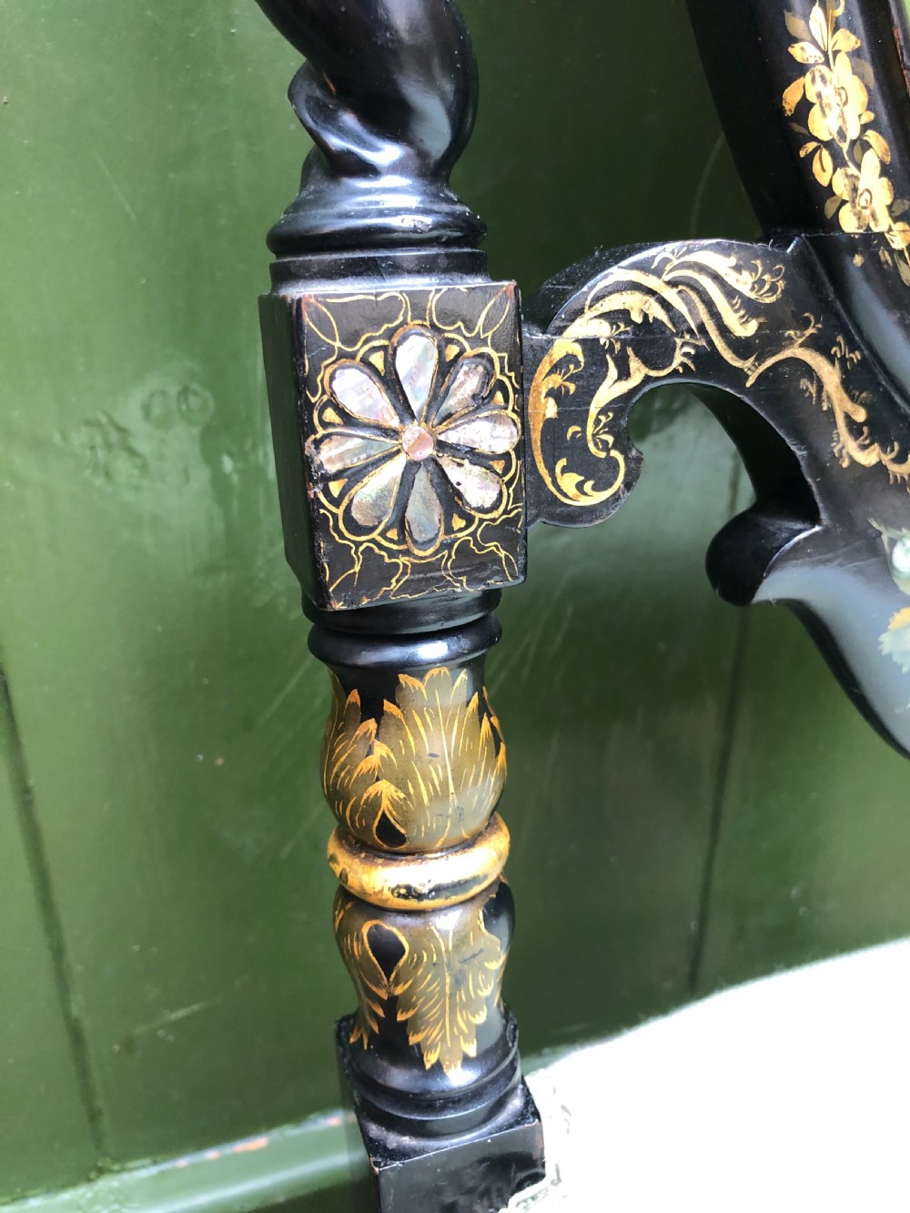 A pair of black lacquered Victorian bedroom chairs featuring oval back panels painted with floral motifs, mother-of-pearl inlay, barley twist legs, and light green upholstered seats. View XIII