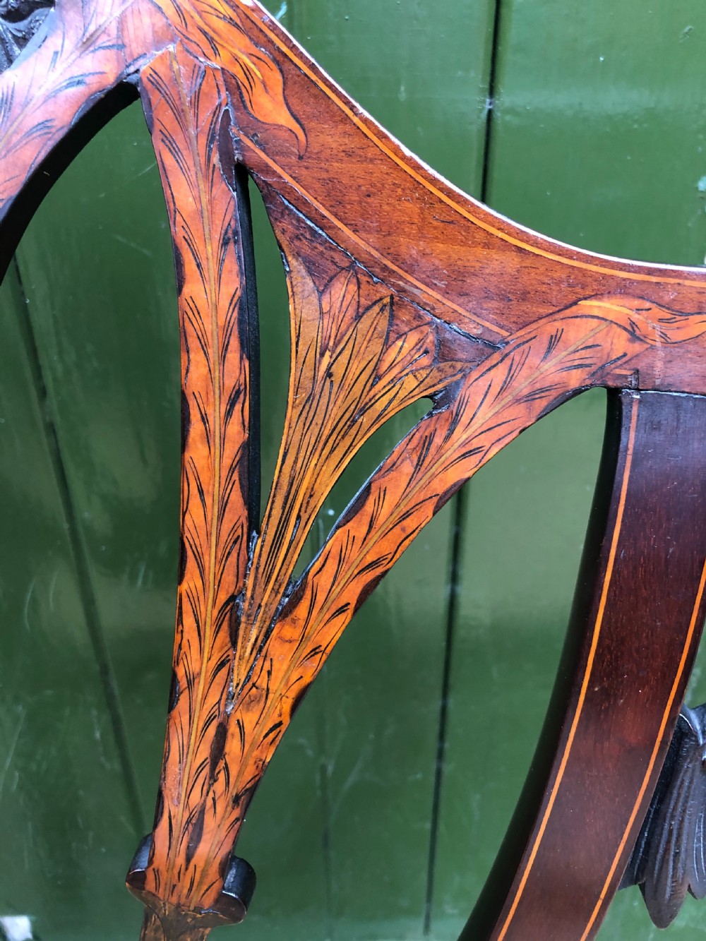 A late nineteenth-century mahogany double chair-back settee featuring shield-shaped backs with satinwood plume inlay and tapered legs. View VII