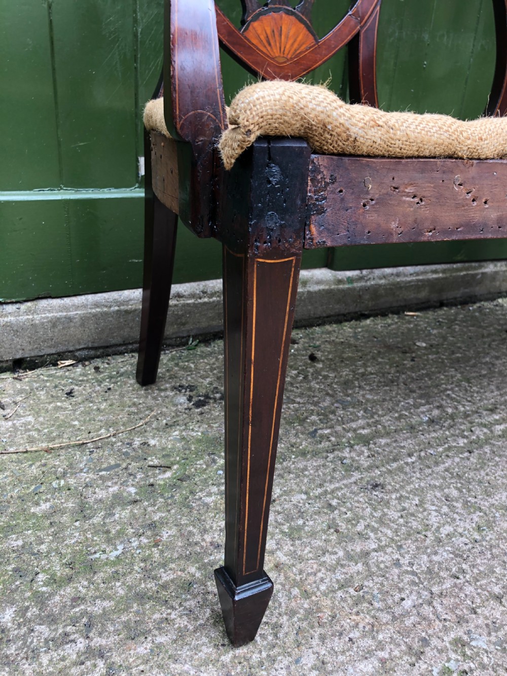 A late nineteenth-century mahogany double chair-back settee featuring shield-shaped backs with satinwood plume inlay and tapered legs. View XII