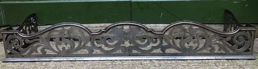 Highly decorative C19th cut-steel fire-place guard or fender in the mid C18th Georgian period revival style .