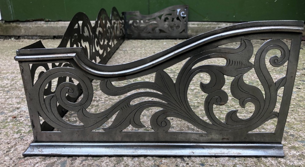 Highly decorative C19th cut-steel fire-place guard or fender in the mid C18th Georgian period revival style . View II
