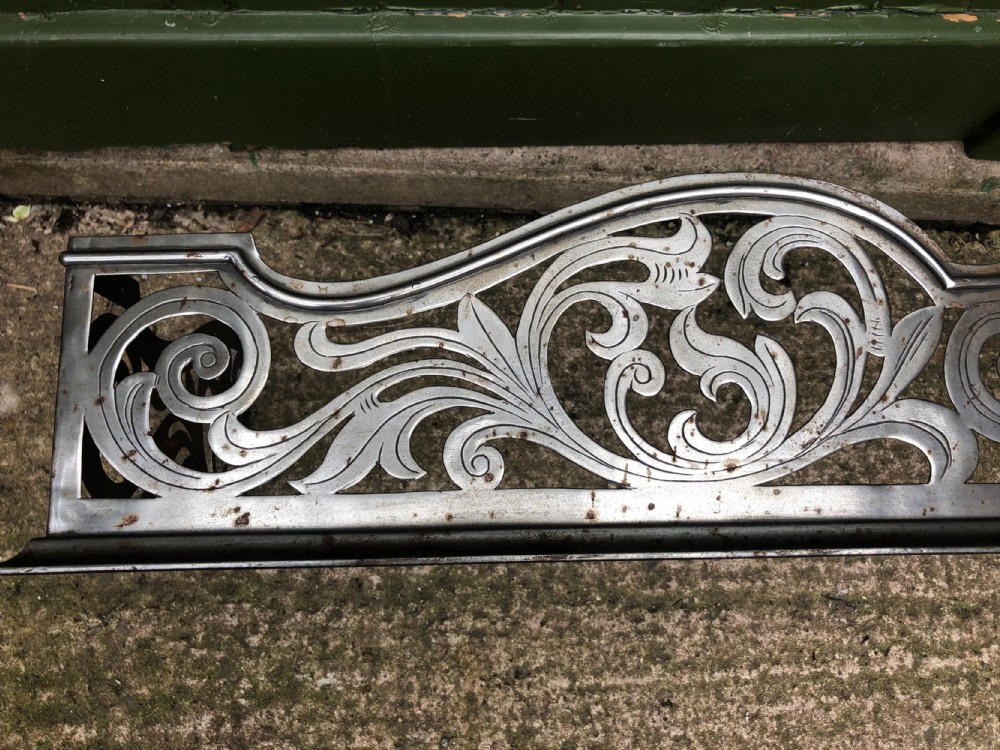 Highly decorative C19th cut-steel fire-place guard or fender in the mid C18th Georgian period revival style . View III