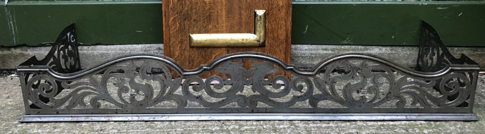 Highly decorative C19th cut-steel fire-place guard or fender in the mid C18th Georgian period revival style . View VII