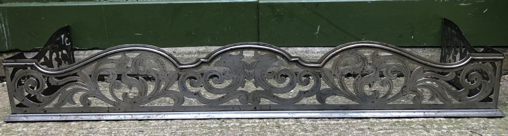 Highly decorative C19th cut-steel fire-place guard or fender in the mid C18th Georgian period revival style . View IX