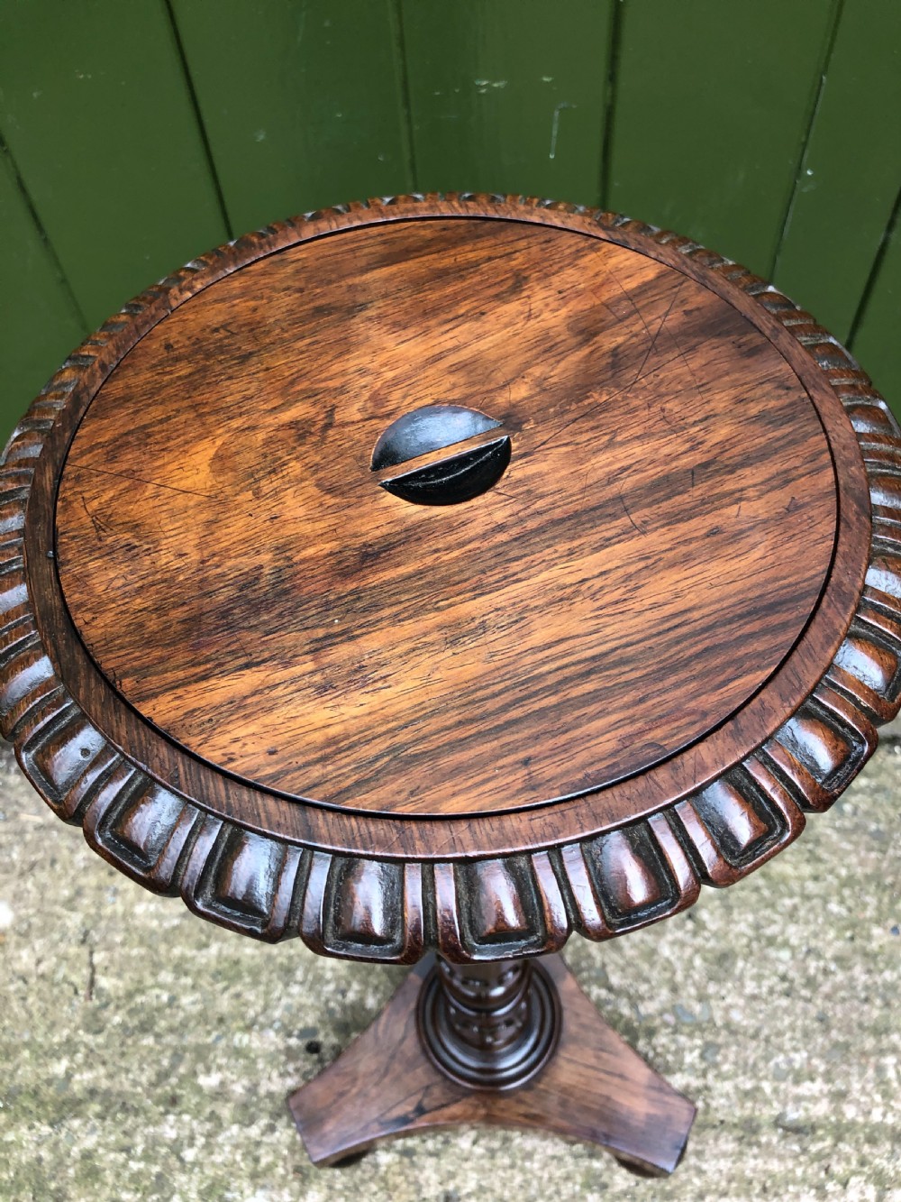 An early 19th-century carved rosewood jardiniere stand featuring a gadrooned top rim, turned column shaft, and a triform base. View VII