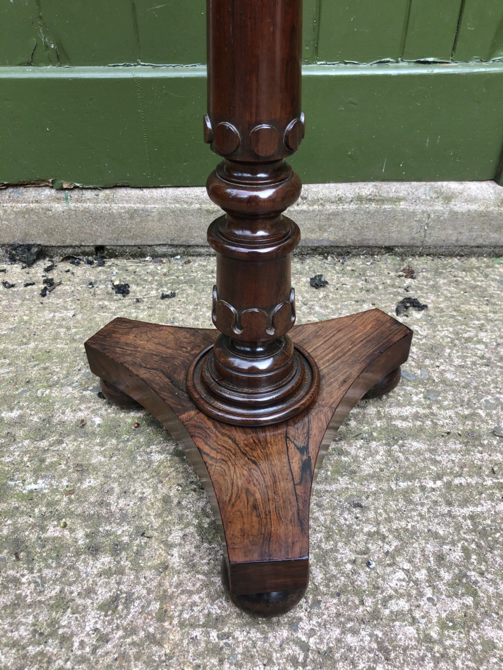 An early 19th-century carved rosewood jardiniere stand featuring a gadrooned top rim, turned column shaft, and a triform base. View III