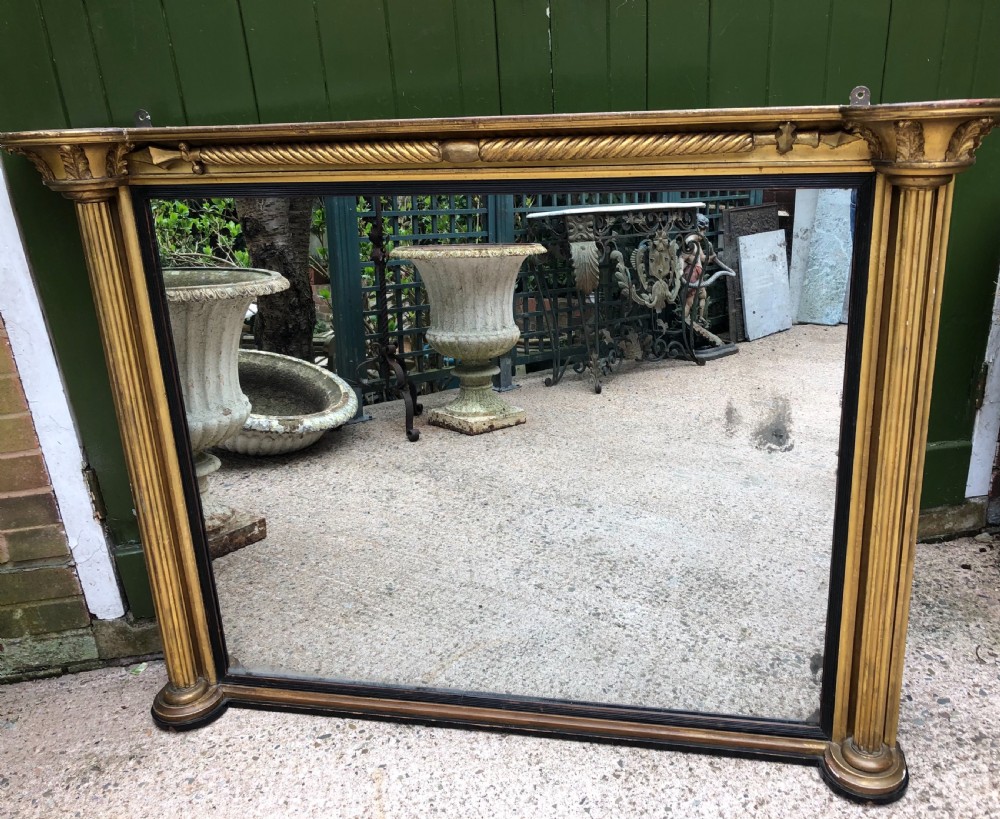 Early C19th Regency period carved giltwood overmantel mirror of practical scale and proportions.