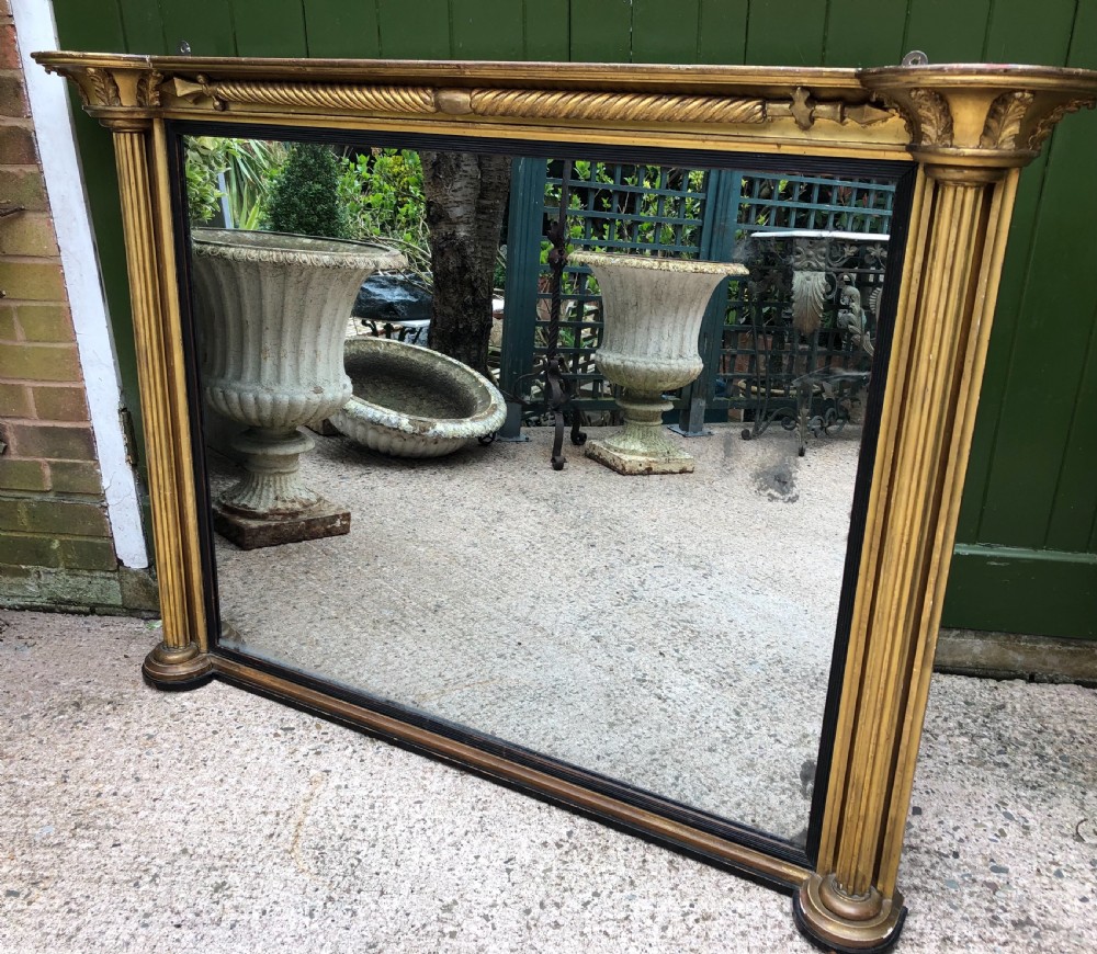 Early C19th Regency period carved giltwood overmantel mirror of practical scale and proportions. View II
