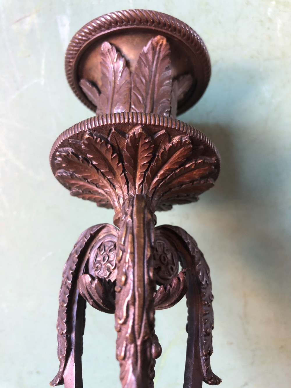 A pair of early nineteenth-century Regency bronze candlesticks designed in classical Athenienne tripod form with leaf sconces and plinth bases. View VIII