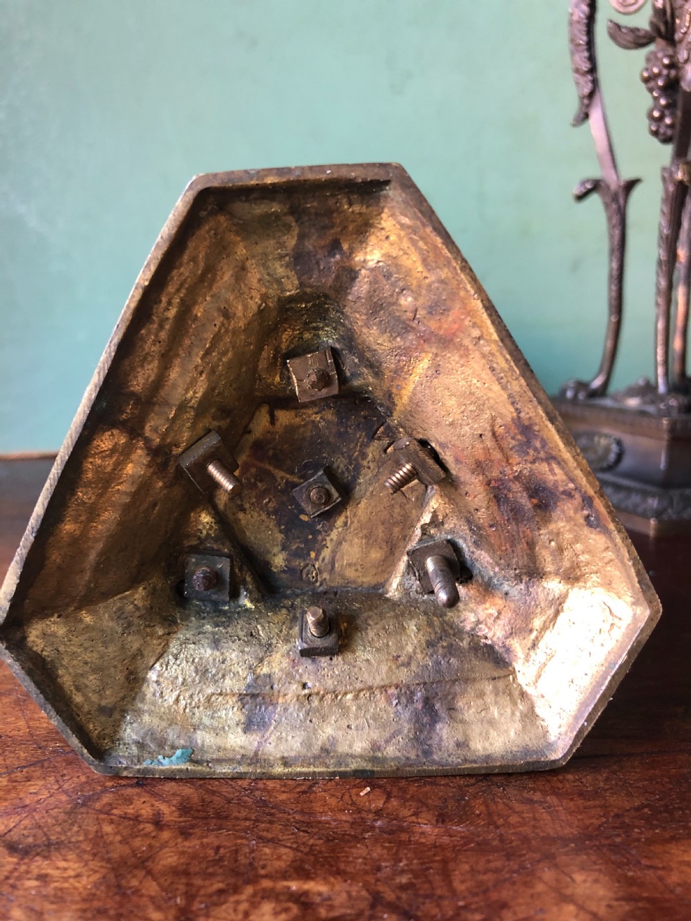 A pair of early nineteenth-century Regency bronze candlesticks designed in classical Athenienne tripod form with leaf sconces and plinth bases. View X