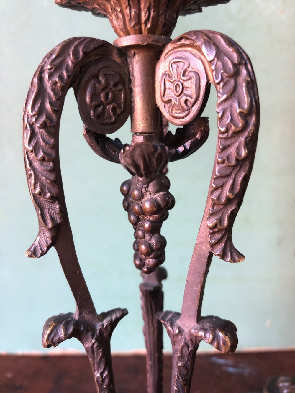 A pair of early nineteenth-century Regency bronze candlesticks designed in classical Athenienne tripod form with leaf sconces and plinth bases. View XIII