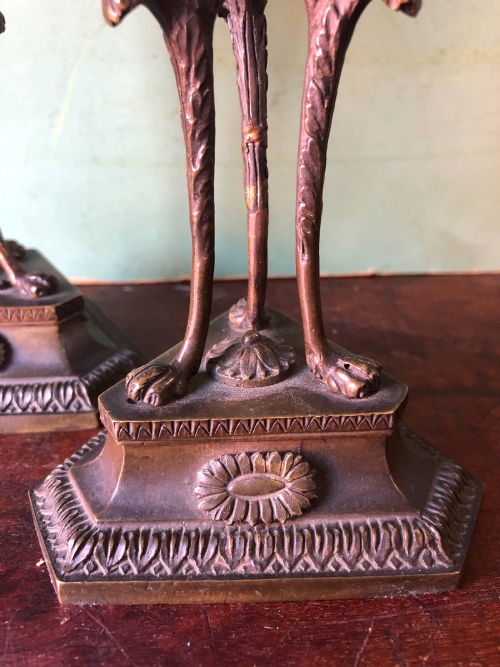 A pair of early nineteenth-century Regency bronze candlesticks designed in classical Athenienne tripod form with leaf sconces and plinth bases. View XIV