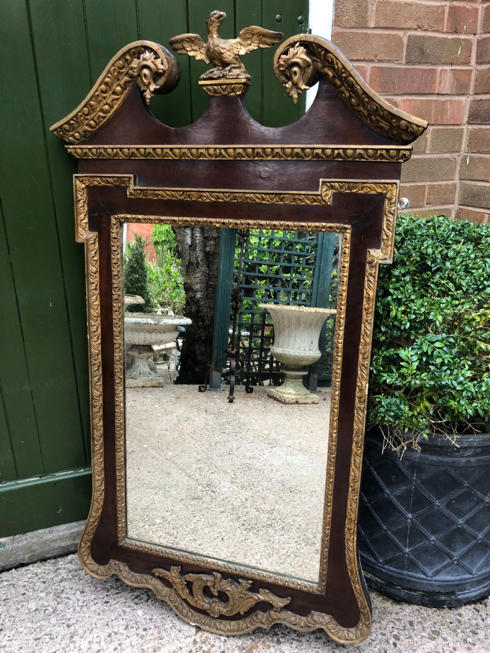 C19th George II period revival walnut and parcel-gilt framed mirror of impressive proportions.