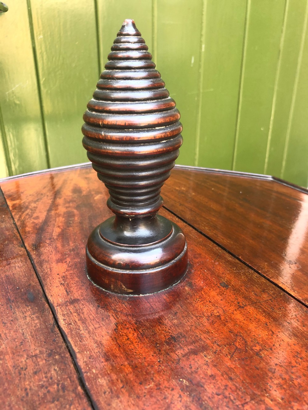 A late eighteenth-century George III mahogany two-tier dumb waiter table featuring octagonal drop-leaf surfaces supported by a turned central column on tripod legs with brass castors. View VII