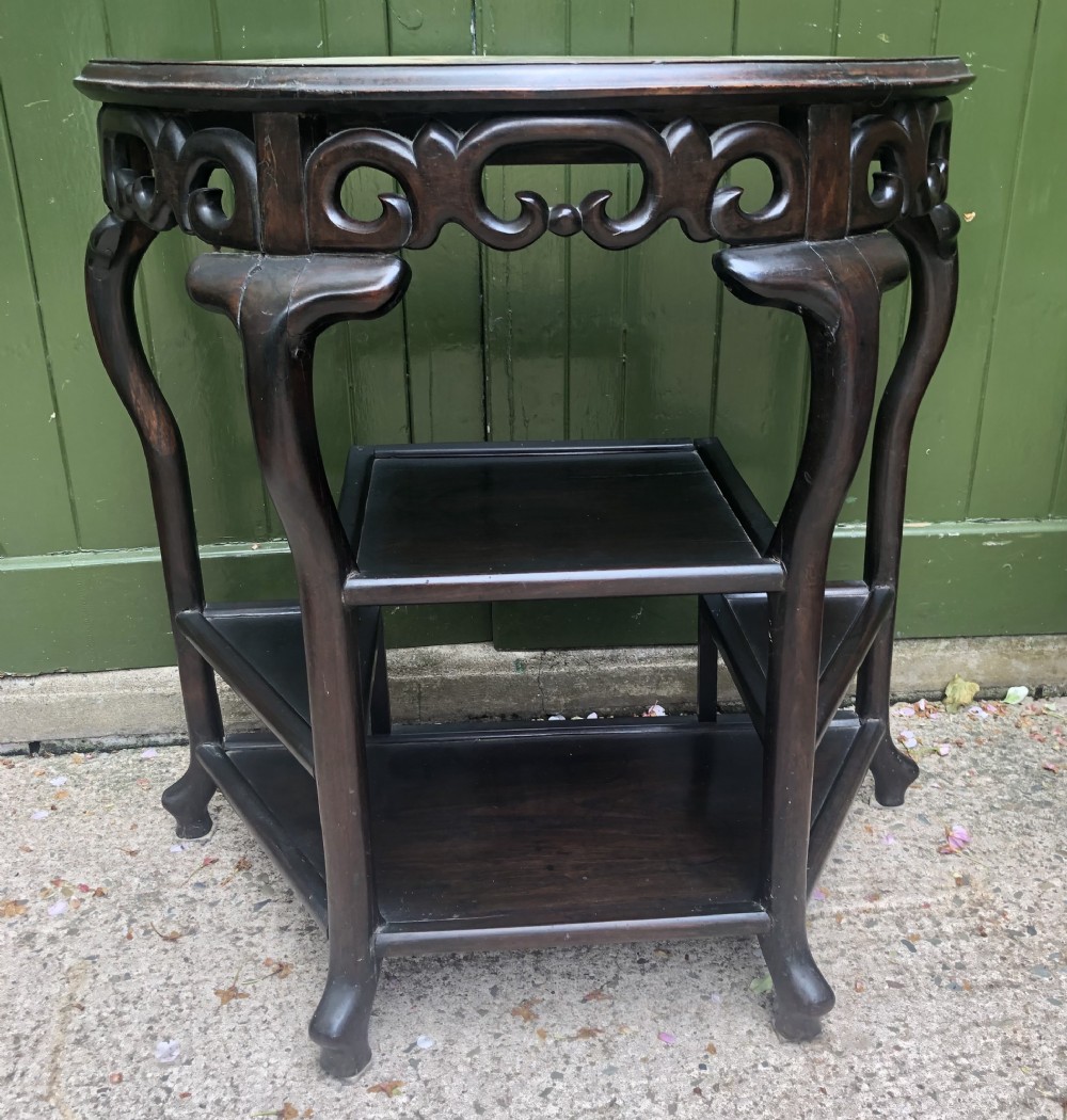 A 19th-century Chinese dark hardwood demi-lune console table featuring an inset variegated marble top, openwork carved frieze, and lower tier shelving. View XIII