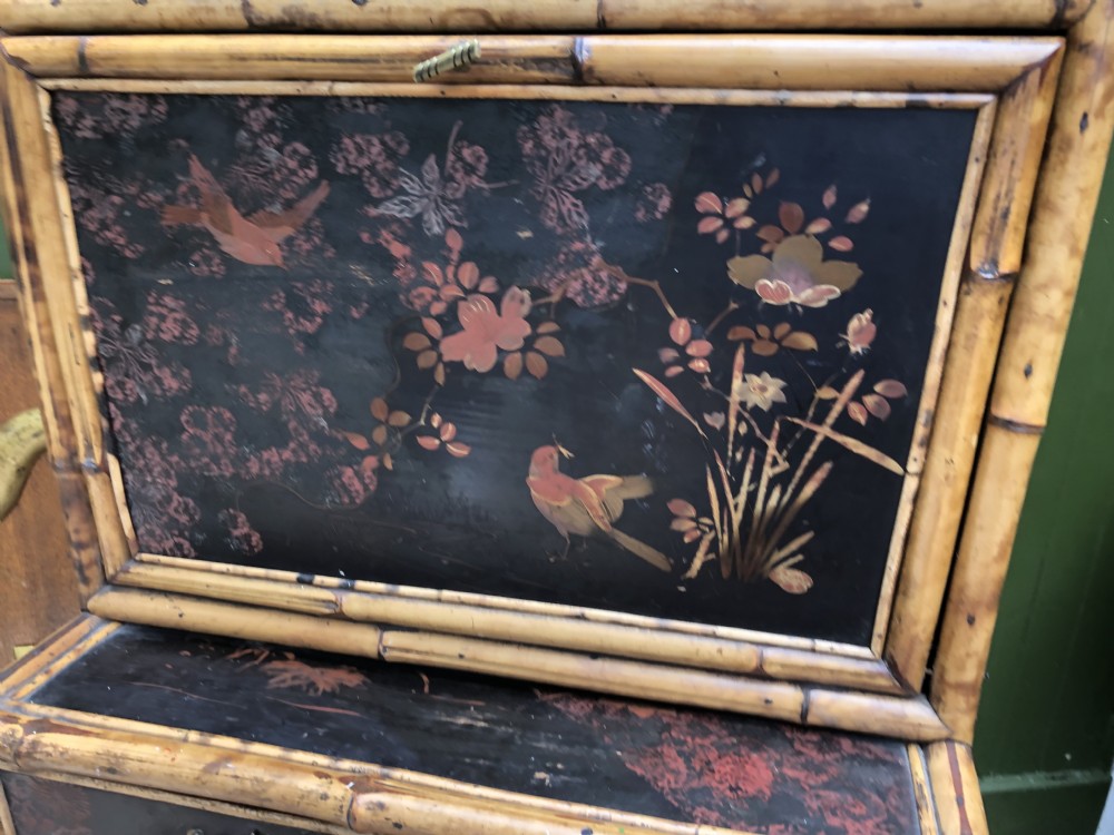 A late 19th-century bamboo escritoire cabinet featuring a pagoda-shaped top finial, a lacquered drop-front writing slope, side shelves, and a lower lacquered cupboard door decorated with floral motifs. View XXIII