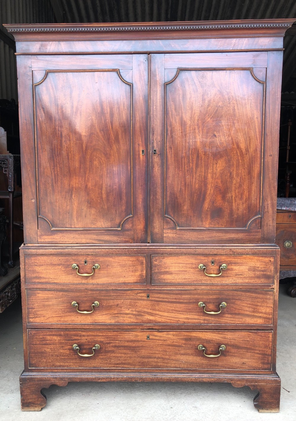 Late C18th George III period mahogany linen-press of small proportions.