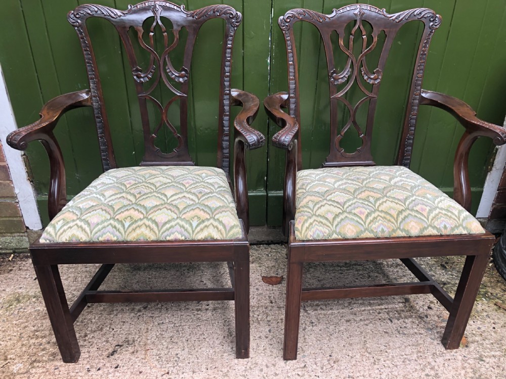 A set of eight carved mahogany Chippendale style dining chairs with decorative pierced back splats and patterned upholstered seats. View XI