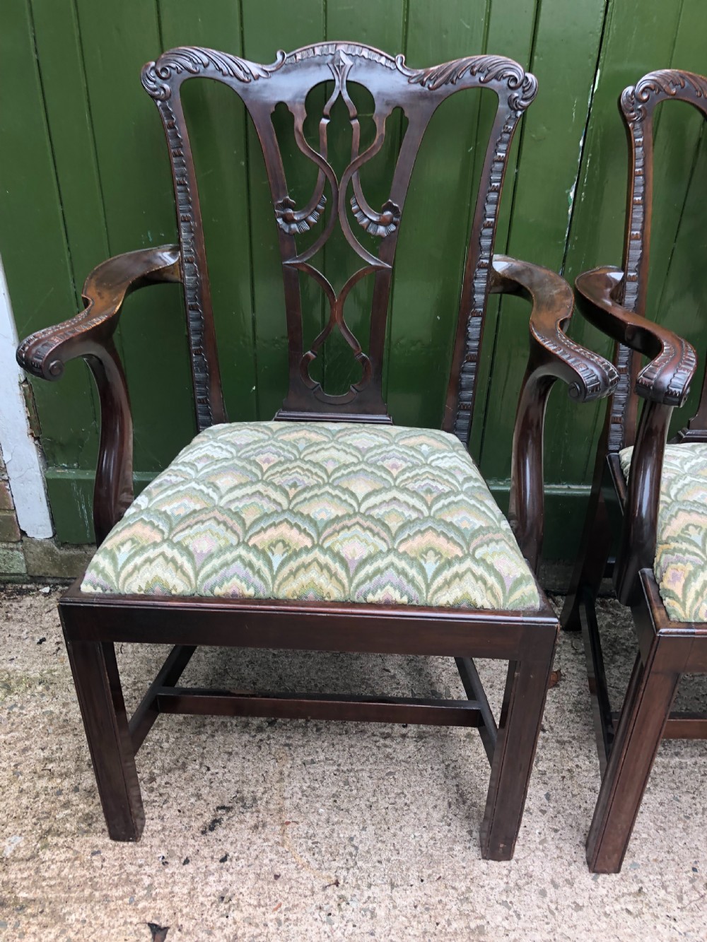 A set of eight carved mahogany Chippendale style dining chairs with decorative pierced back splats and patterned upholstered seats. View XII