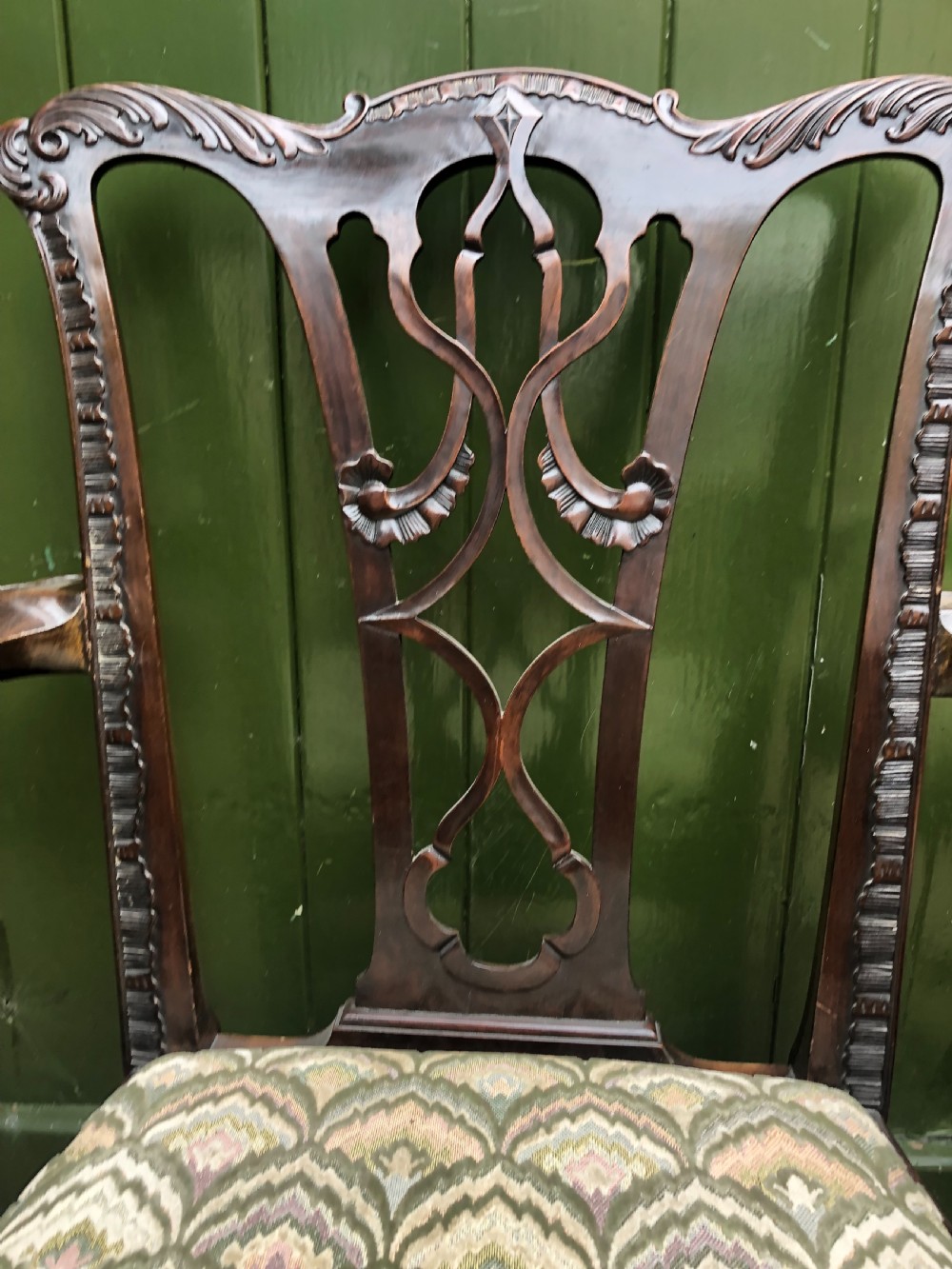 A set of eight carved mahogany Chippendale style dining chairs with decorative pierced back splats and patterned upholstered seats. View XIV
