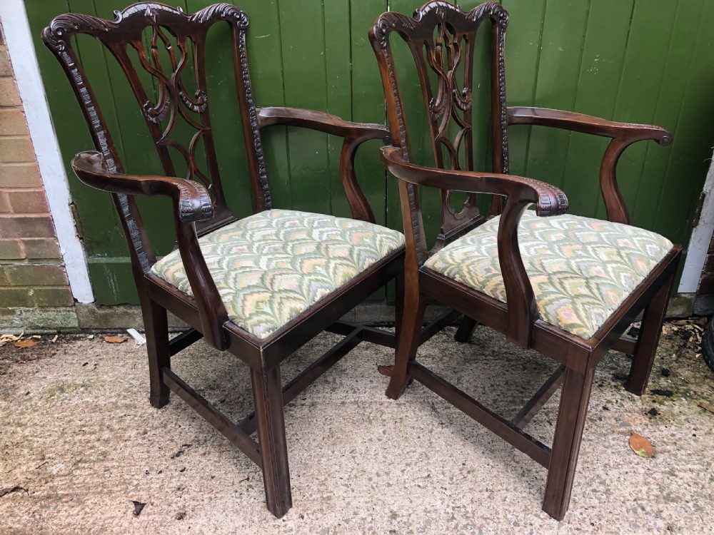 A set of eight carved mahogany Chippendale style dining chairs with decorative pierced back splats and patterned upholstered seats. View XV