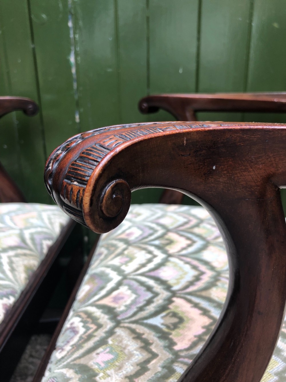 A set of eight carved mahogany Chippendale style dining chairs with decorative pierced back splats and patterned upholstered seats. View XVII