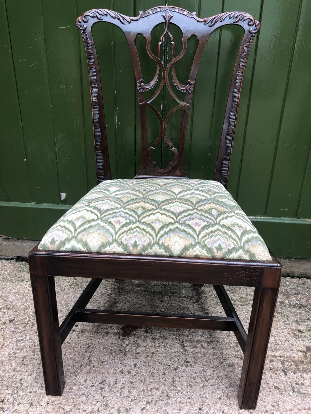 A set of eight carved mahogany Chippendale style dining chairs with decorative pierced back splats and patterned upholstered seats. View XIX