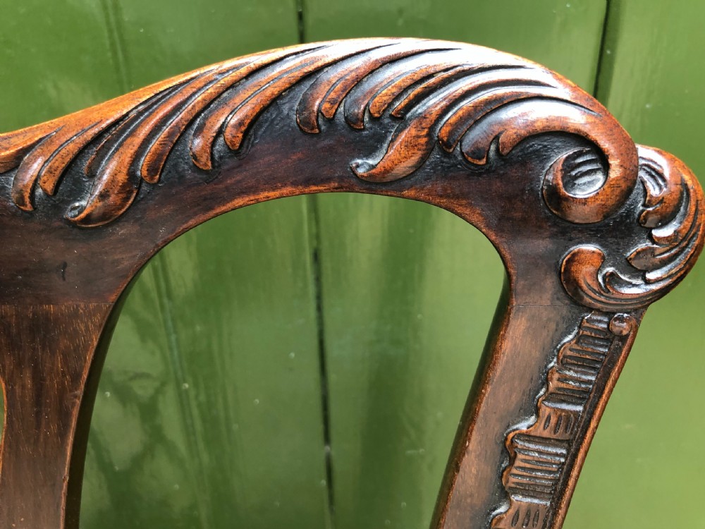 A set of eight carved mahogany Chippendale style dining chairs with decorative pierced back splats and patterned upholstered seats. View XXIII
