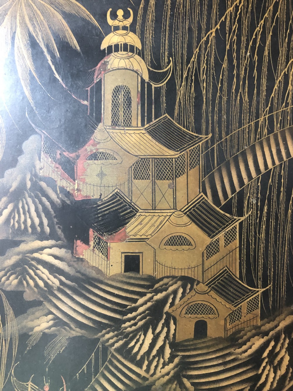 A rectangular black lacquered Regency papier-mache tray featuring gilded chinoiserie landscape decoration and two brass side handles. View VII