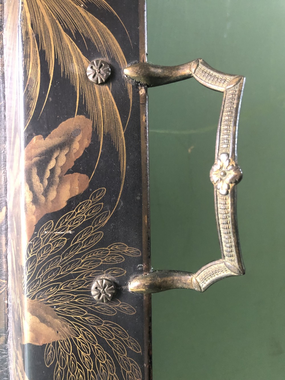A rectangular black lacquered Regency papier-mache tray featuring gilded chinoiserie landscape decoration and two brass side handles. View VIII