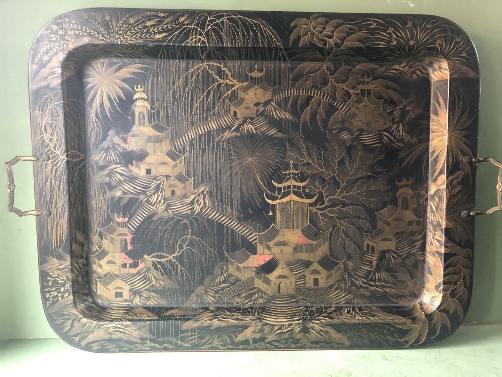 A rectangular black lacquered Regency papier-mache tray featuring gilded chinoiserie landscape decoration and two brass side handles. View XII