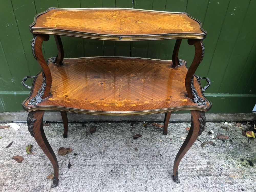 An early nineteenth-century French two-tier etagere table featuring detailed floral marquetry inlay, cabriole legs, brass galleries, and metal side handles. View VIII