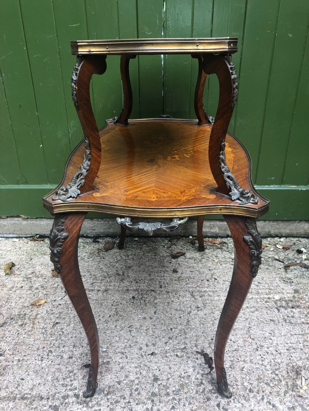 An early nineteenth-century French two-tier etagere table featuring detailed floral marquetry inlay, cabriole legs, brass galleries, and metal side handles. View XI