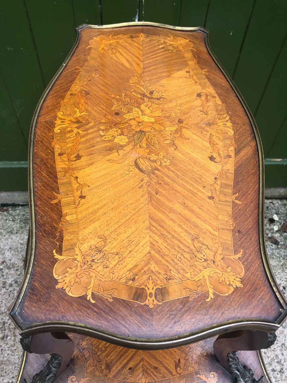 An early nineteenth-century French two-tier etagere table featuring detailed floral marquetry inlay, cabriole legs, brass galleries, and metal side handles. View XII