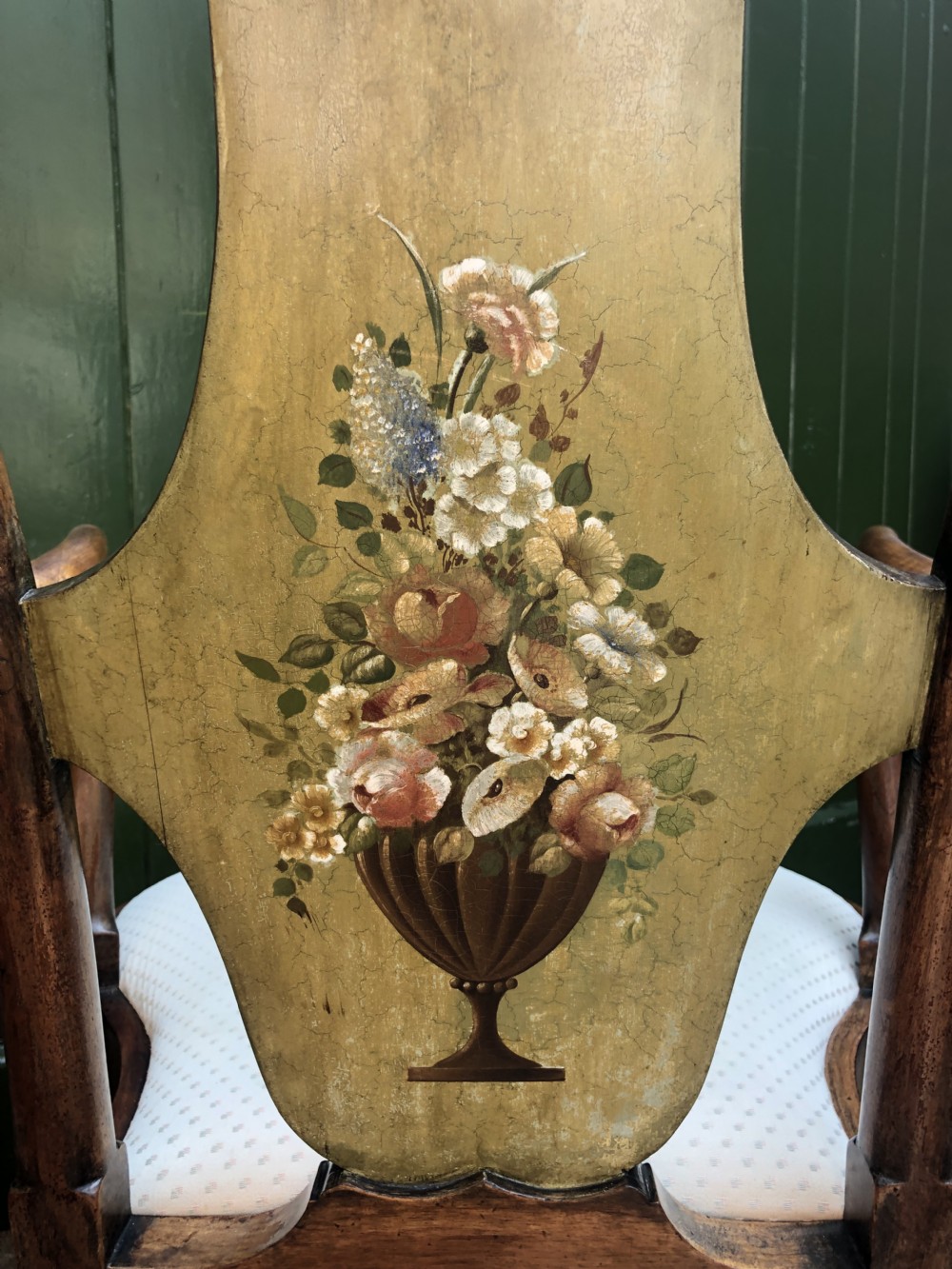 Early 20th-century Queen Anne revival walnut armchair featuring a painted floral splat back, carved armrests, cabriole legs, and cream upholstery. View VI