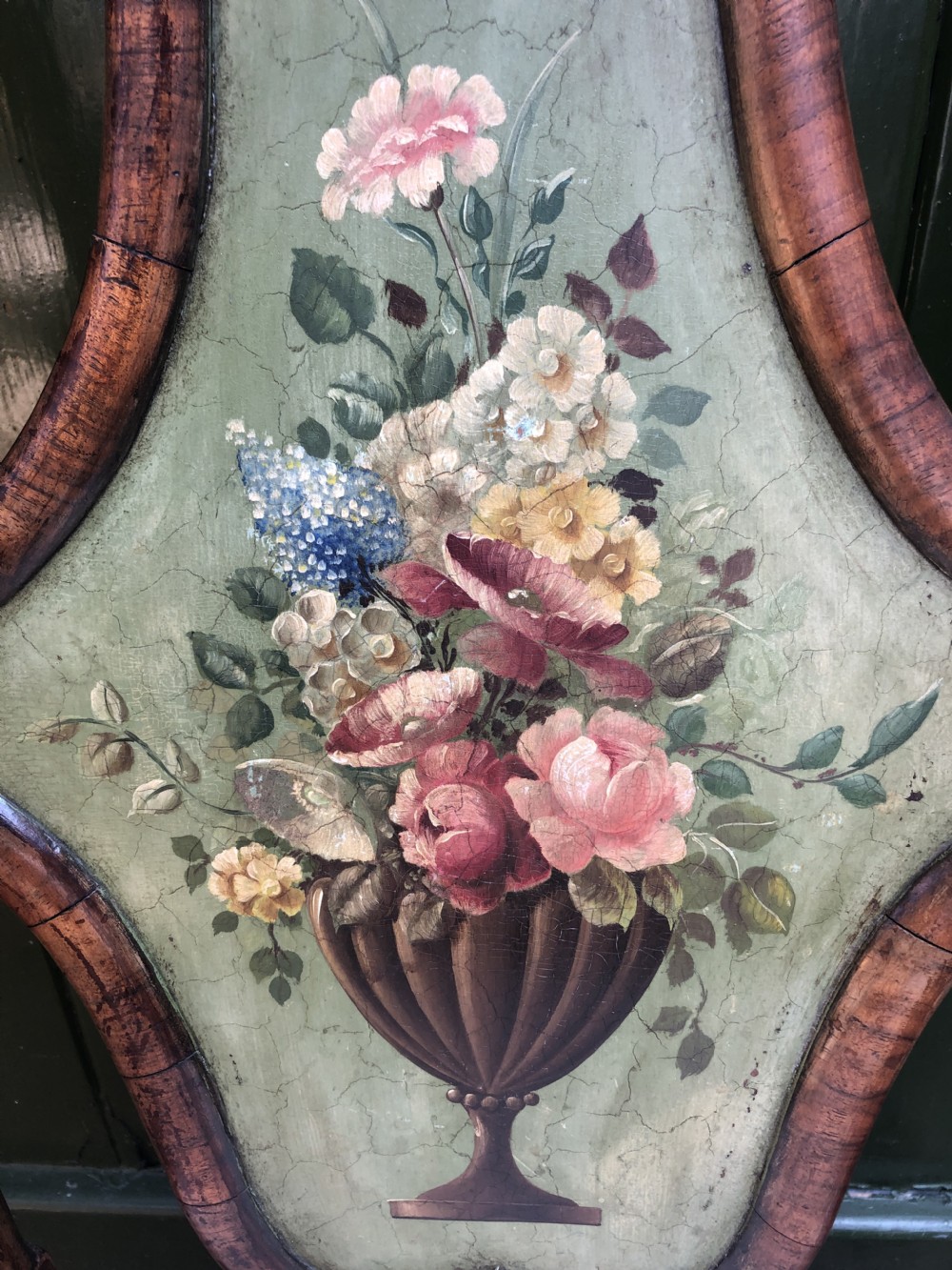 Early 20th-century Queen Anne revival walnut armchair featuring a painted floral splat back, carved armrests, cabriole legs, and cream upholstery. View X
