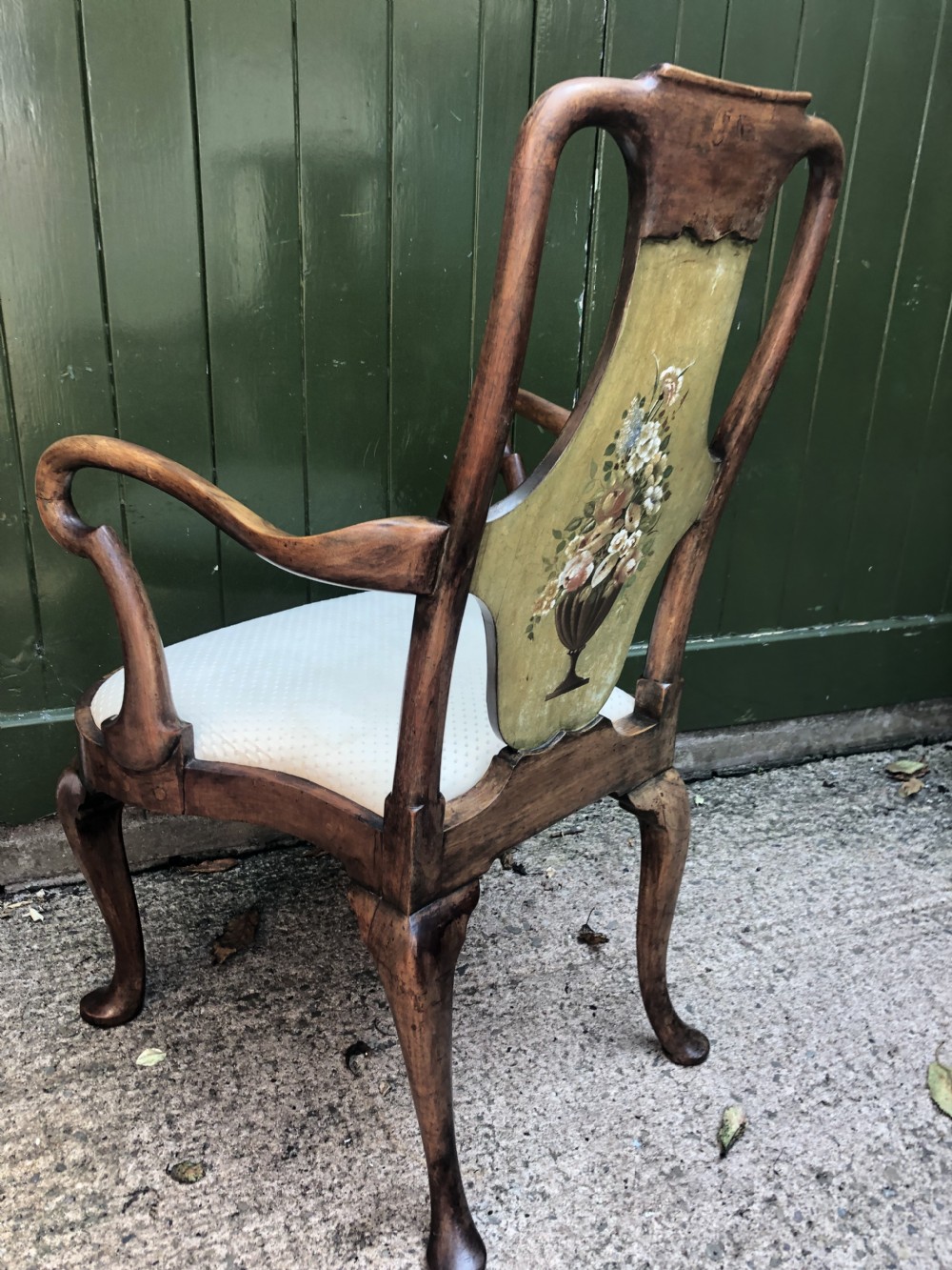 Early 20th-century Queen Anne revival walnut armchair featuring a painted floral splat back, carved armrests, cabriole legs, and cream upholstery. View XIII