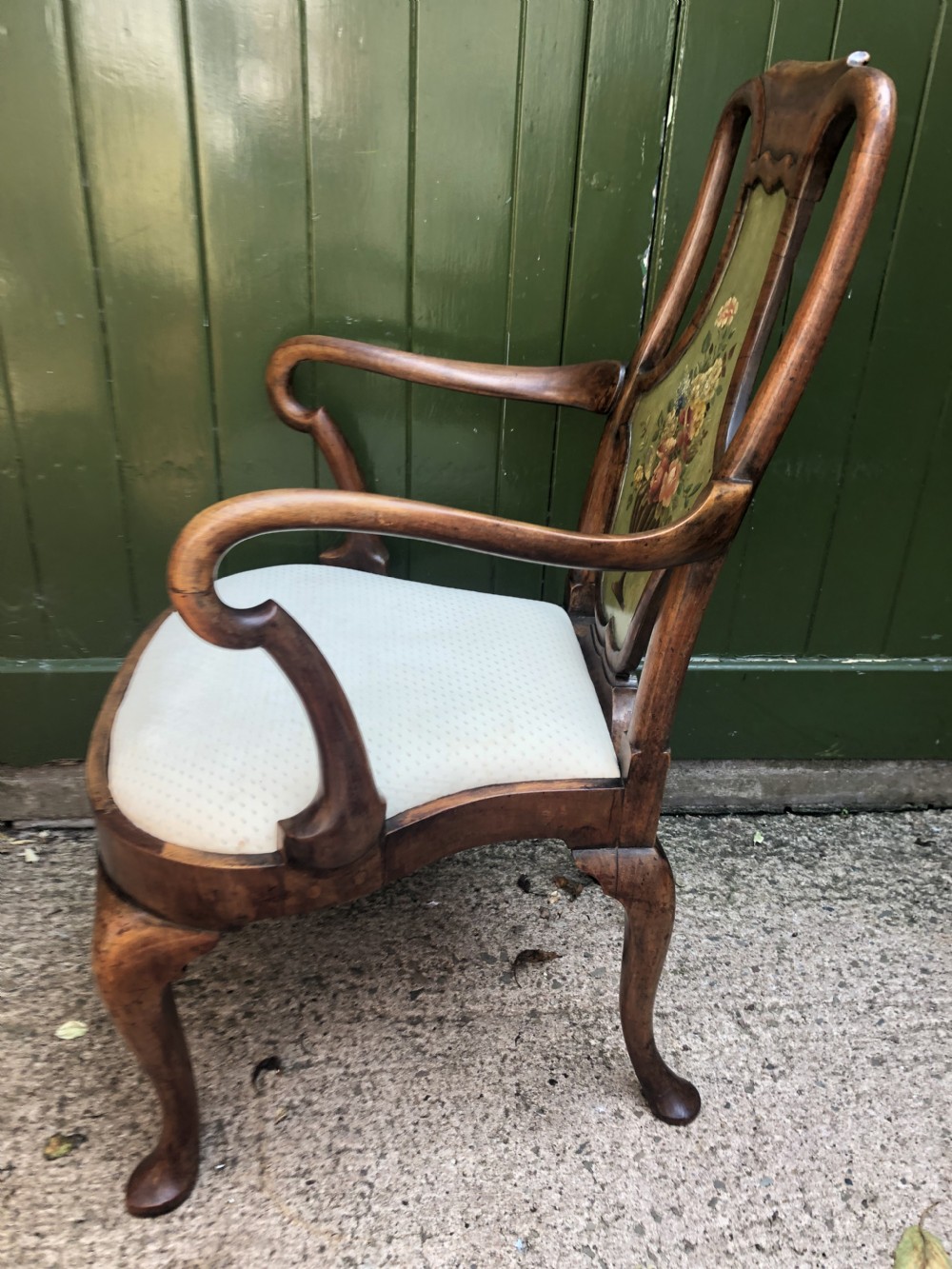 Early 20th-century Queen Anne revival walnut armchair featuring a painted floral splat back, carved armrests, cabriole legs, and cream upholstery. View XIV