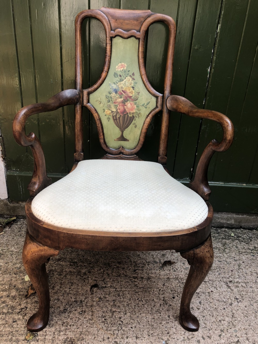 Early 20th-century Queen Anne revival walnut armchair featuring a painted floral splat back, carved armrests, cabriole legs, and cream upholstery. View XV