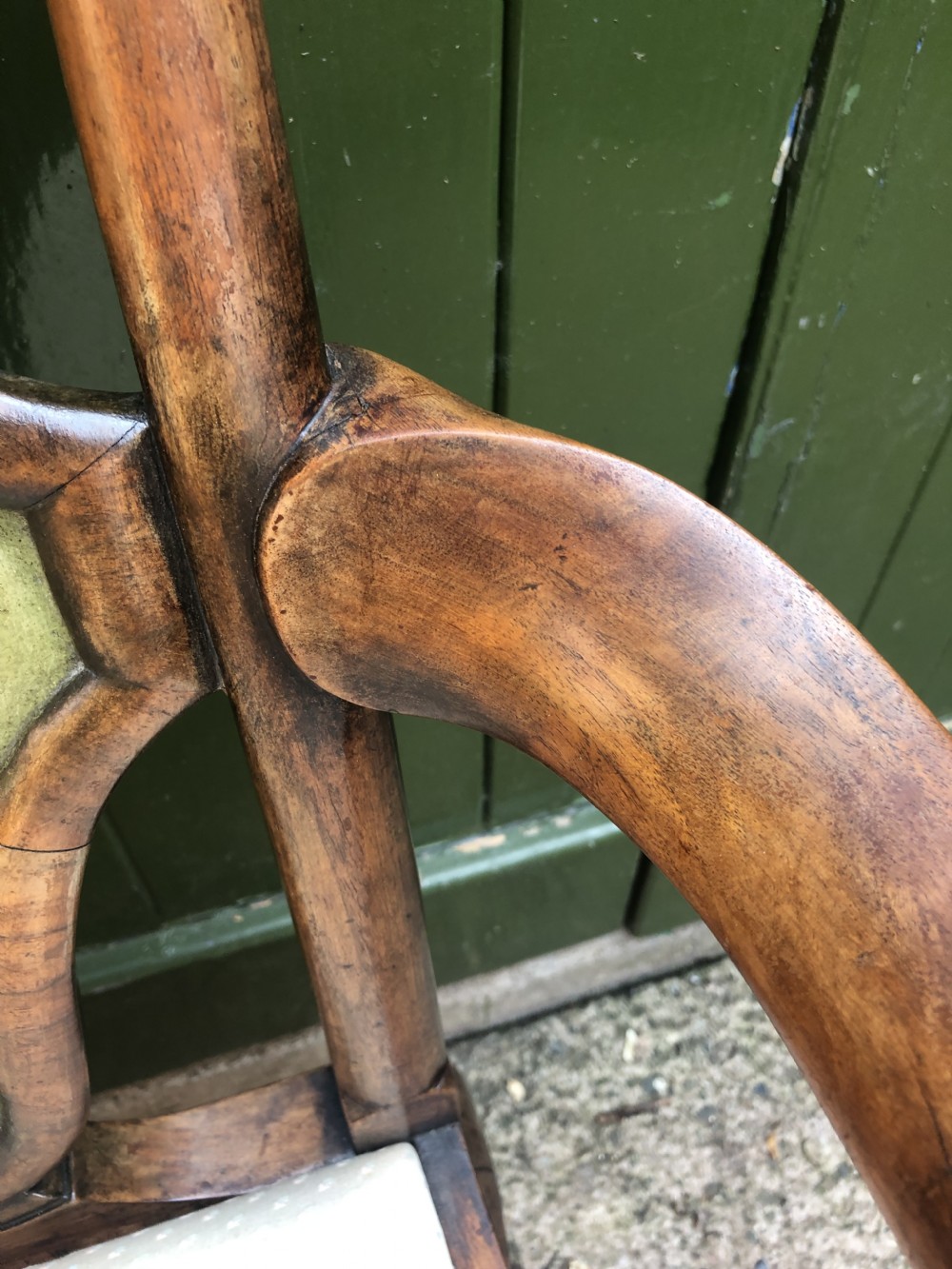 Early 20th-century Queen Anne revival walnut armchair featuring a painted floral splat back, carved armrests, cabriole legs, and cream upholstery. View XVI