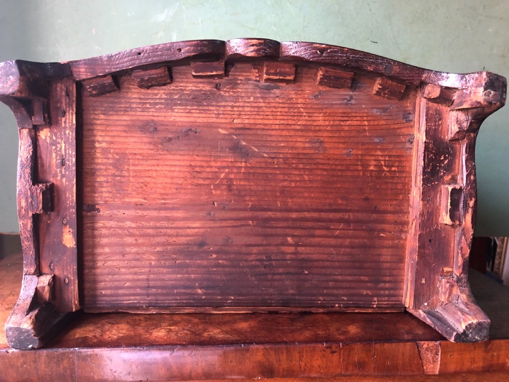 An early nineteenth-century miniature mahogany bow-front chest of drawers featuring brass ring handles and keyholes. View X