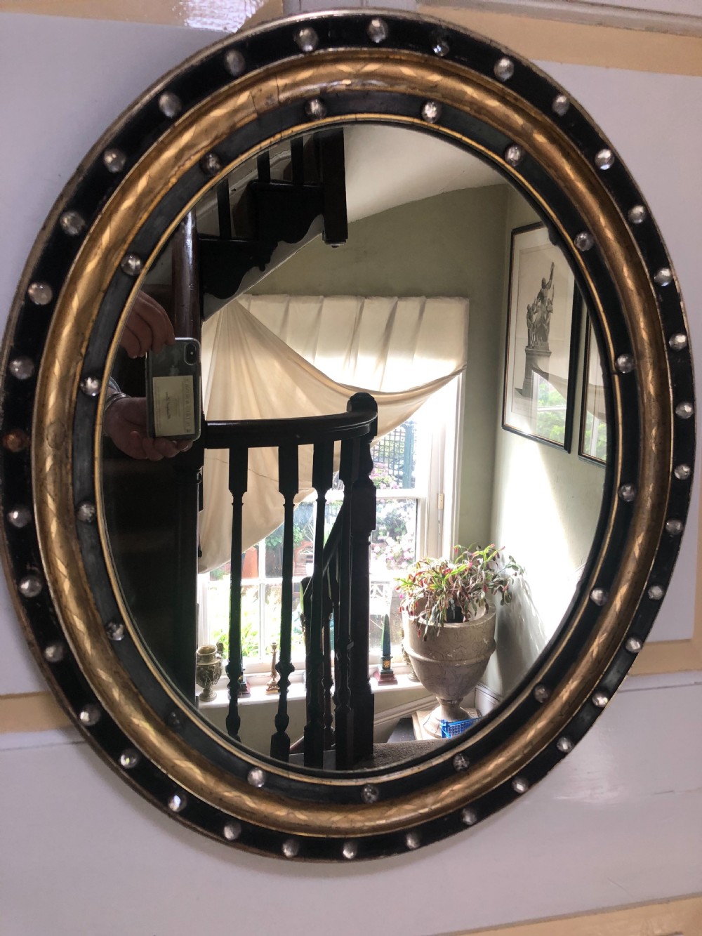 C19th Irish oval mirror with ebonised and gilded glass facet mounted frame with silvered outer edge . View VI