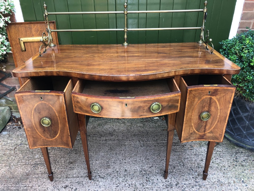 Fine late C18th George III Sheraton period mahogany serpentine front sideboard of compact proportions. View V