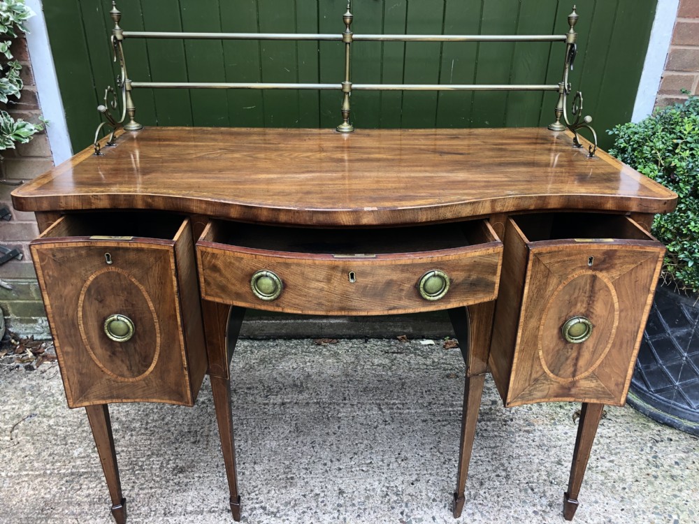 Fine late C18th George III Sheraton period mahogany serpentine front sideboard of compact proportions. View XXIV