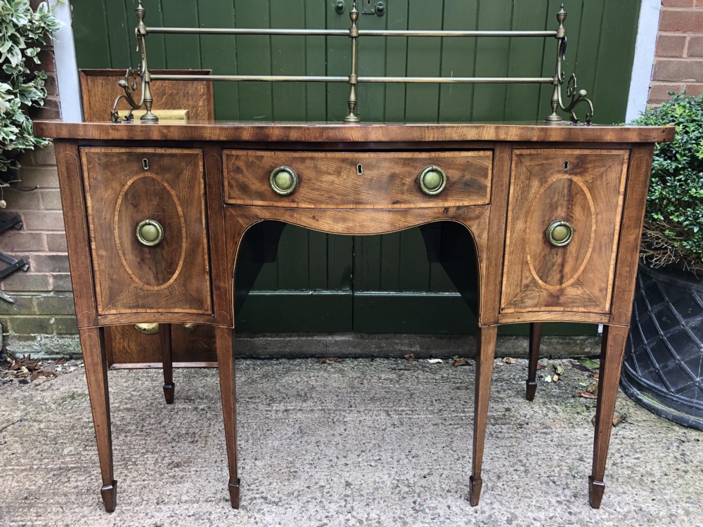 Fine late C18th George III Sheraton period mahogany serpentine front sideboard of compact proportions. View XXVI