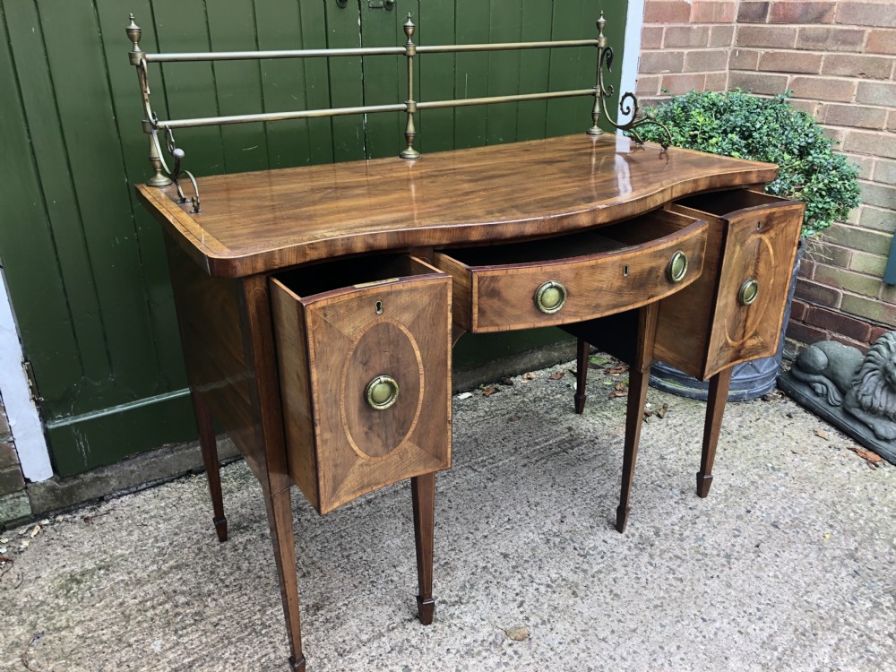 Fine late C18th George III Sheraton period mahogany serpentine front sideboard of compact proportions. View XXVII