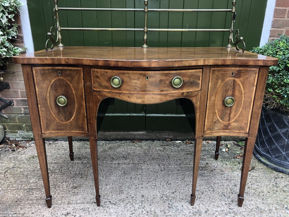 Fine late C18th George III Sheraton period mahogany serpentine front sideboard of compact proportions. View XXVIII