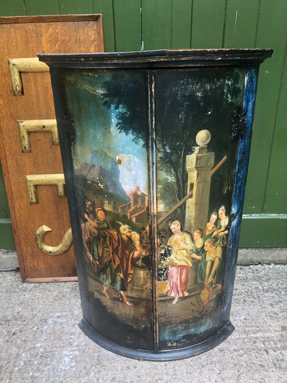 C18th Dutch bow-front hanging corner cupboard decorated with an exotic figural scene. View II