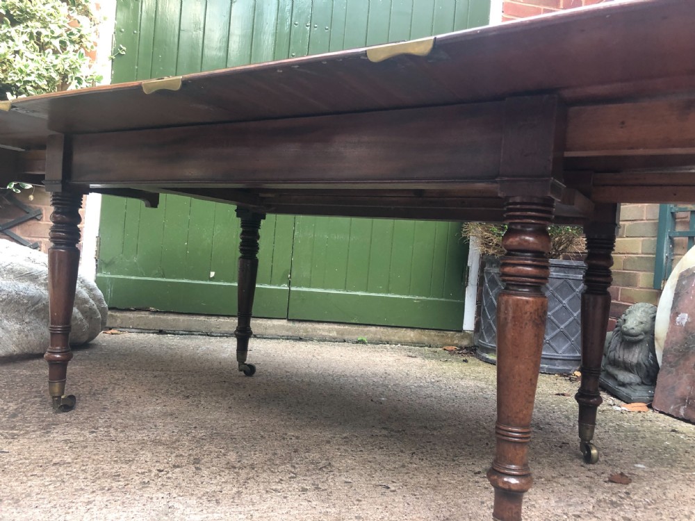Elegant early C19th Regency period  mahogany extending dining table of unusual design and format. View XI